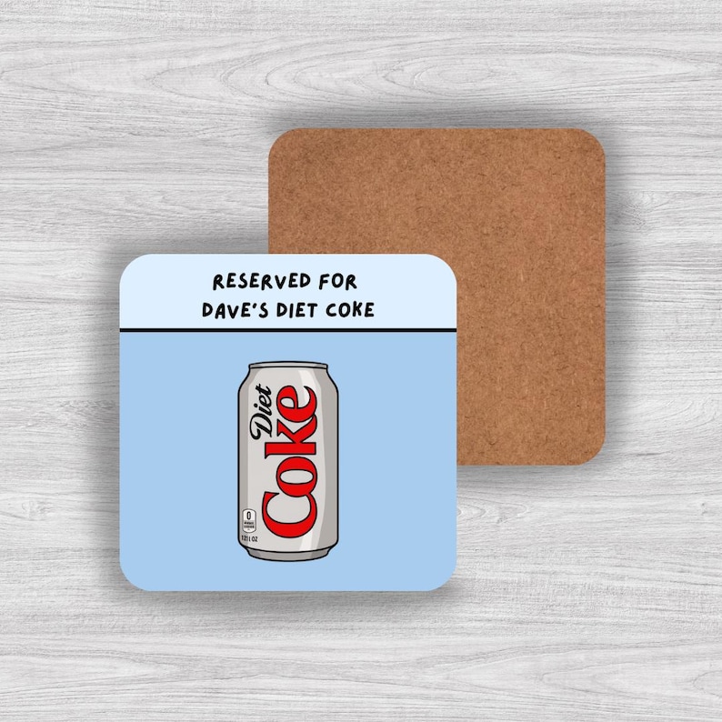 May include: A square coaster with a light blue background and a cork backing. The top section features the black text RESERVED FOR DAVE'S DIET COKE. Below this, a graphic of a silver Diet Coke can with red lettering is centered on the coaster.