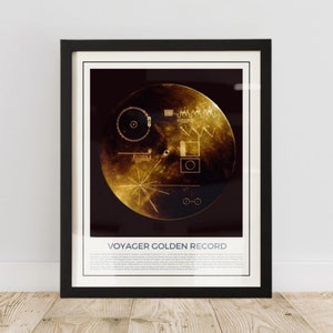 May include: Framed print of the Voyager Golden Record. The artwork features a gold-toned disc with intricate diagrams and symbols against a dark background. The title "VOYAGER GOLDEN RECORD" is printed at the bottom.