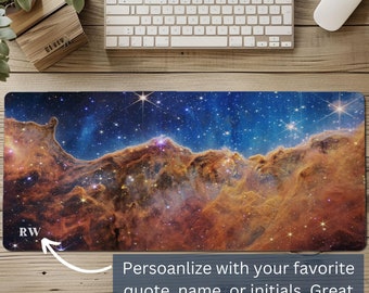 May include: A personalized mousepad with a colorful nebula image. The mousepad features a dark blue background with orange and yellow nebula clouds and stars. The text "RW" is visible in the lower left corner of the mousepad.