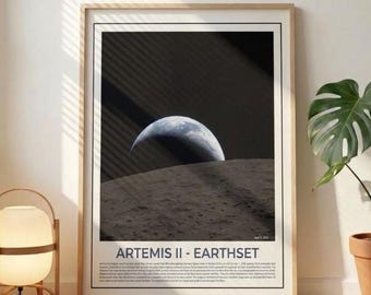 May include: Framed print featuring a photograph of Earth rising over a lunar surface. The image is dominated by a dark sky and a crescent-shaped Earth. The print is labeled "ARTEMIS II - EARTHSET".