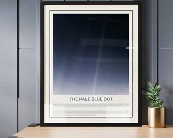 May include: A framed print of a photograph of Earth, taken from space, with the caption "The Pale Blue Dot". The image shows Earth as a small, pale blue dot against a dark background of space.