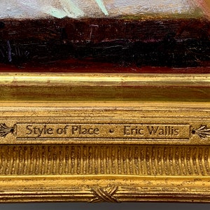 May include: Close-up of a framed painting with a gold-colored ornate frame. The painting is partially visible, with visible brushstrokes and colors. A small plaque on the frame reads "Style of Place • Eric Wallis."