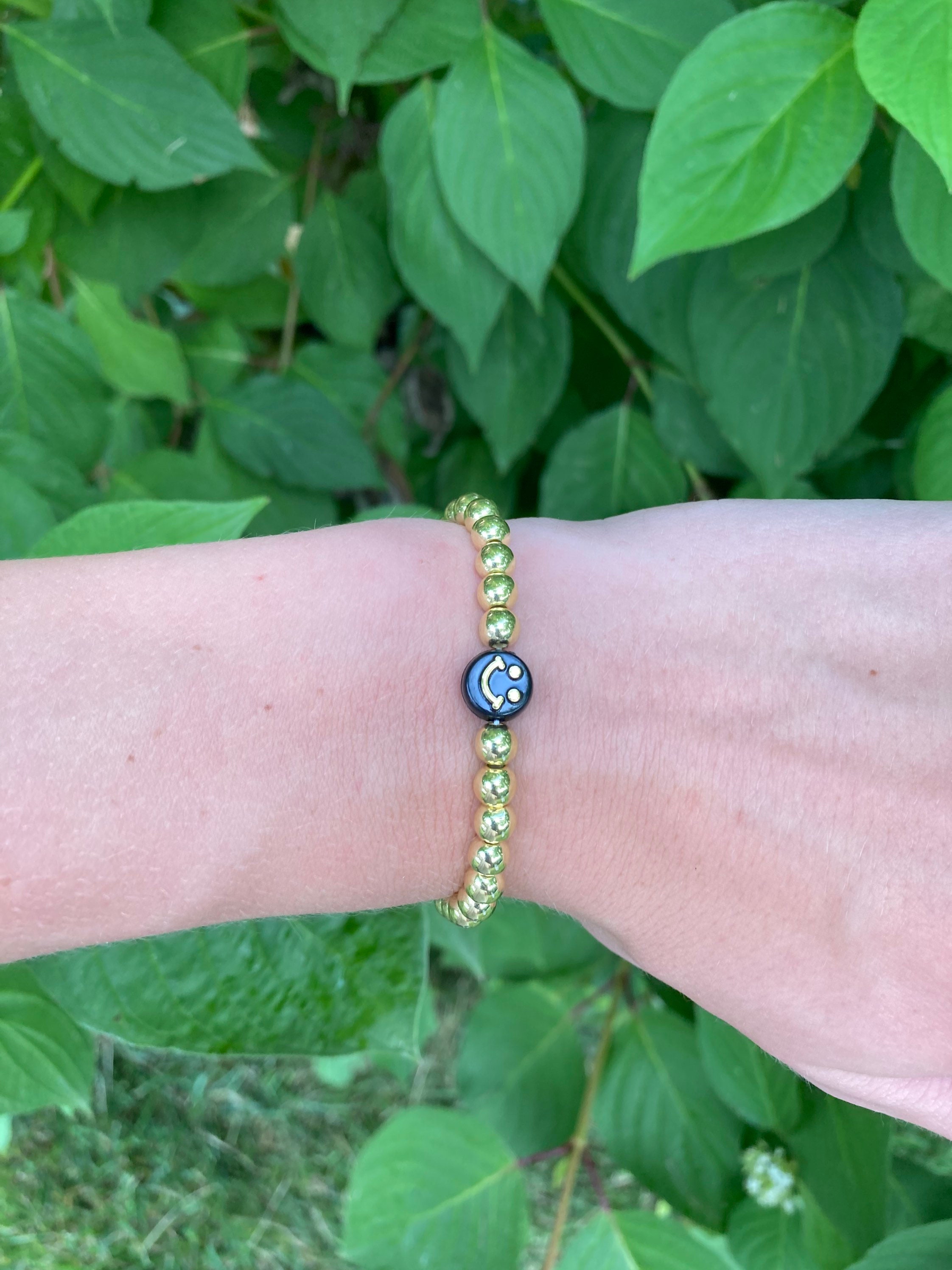Gold and black smiley face beaded bracelet. Etsy