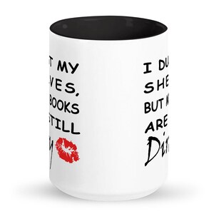 May include: Three white mugs with black interiors and black handles. Each mug has a different variation of the text "I dust my shelves, but my books are still dirty" with a red lipstick kiss mark.