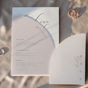 May include: A wedding invitation suite with a modern design. The invitation card is cream with a rounded edge and features the text "Line Details" in black calligraphy. The reception card is a light pink with a rounded edge and includes details about the reception, accommodation, and website. The RSVP card is a light pink with a rounded edge and features the text "RSVP" in black calligraphy.