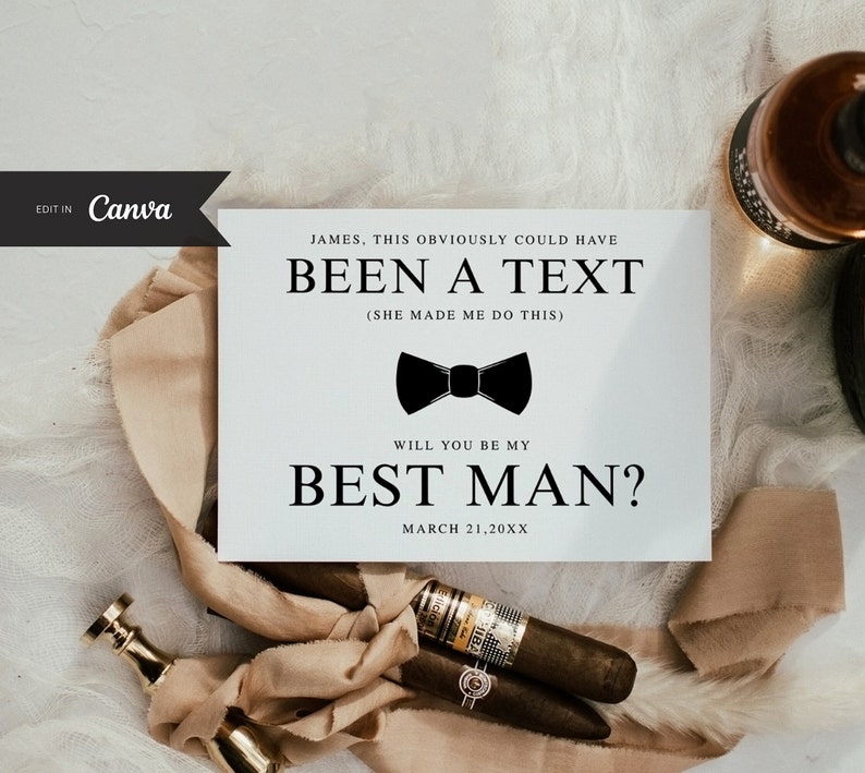 May include: A white card with black text that reads 'JAMES. THIS OBVIOUSLY COULD HAVE BEEN A TEXT (SHE MADE ME DO THIS) WILL YOU BE MY BEST MAN? MARCH 21,20XX' with a black bow tie icon in the center.