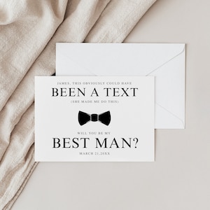 May include: A white card with black text that reads 'JAMES, THIS OBVIOUSLY COULD HAVE BEEN A TEXT (SHE MADE ME DO THIS)' and a black bow tie icon. Below the bow tie is the text 'WILL YOU BE MY BEST MAN?' and the date 'MARCH 21, 20XX'.