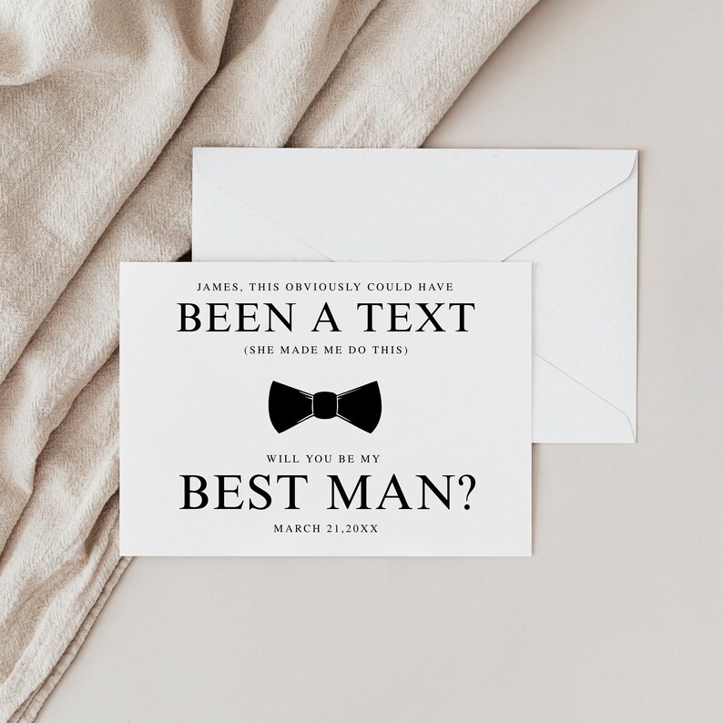 May include: A white card with black text that reads 'JAMES, THIS OBVIOUSLY COULD HAVE BEEN A TEXT (SHE MADE ME DO THIS)' and a black bow tie icon. Below the bow tie is the text 'WILL YOU BE MY BEST MAN?' and the date 'MARCH 21, 20XX'.