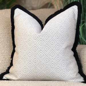 Neutral cream beige diamond patterned cushion cover with black fringe trim - luxury modern decor