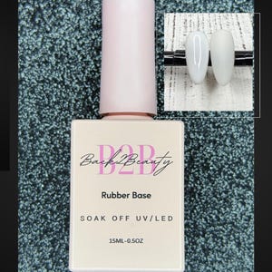 May include: A pink bottle of nail polish with the text "Back2Beauty" and "Rubber Base" on the label. The bottle is labeled "SOAK OFF UV/LED" and "15ML-0.5OZ".