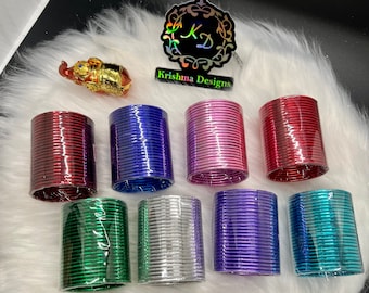 May include: A set of eight colorful metal bangles, each with a shiny metallic finish. The bangles are stacked in a pile, with the colors red, blue, pink, green, silver, purple, and teal visible. The bangles are packaged in clear plastic wrap.