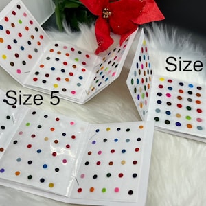 May include: Four packs of colorful round adhesive bindis in different sizes. The packs are labeled "Size 4", "Size 5", and "Size 6".