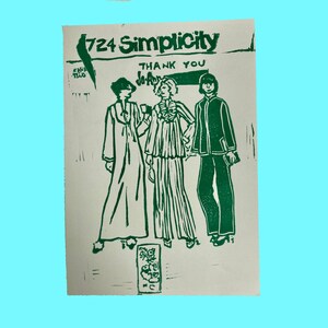 May include: A vintage Simplicity sewing pattern with the number 724 printed on it. The pattern features three women wearing different styles of clothing. The text "Thank You" is printed on the pattern.