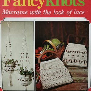 May include: A book cover titled "Fancyknots" with the subtitle "Macrame with the look of lace." The cover features images of macrame plant hangers and purses. The book is by Judy Peacher and Lucille Hammons, with 14 projects.