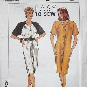 May include: Simplicity Easy to Sew pattern showing two button-down dress designs. One dress has black sleeves and a white body, the other is a solid yellow-orange colour. The pattern size is U5 (16-24).
