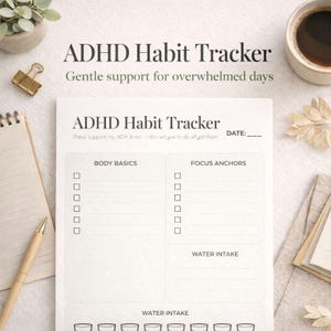 May include: A white ADHD habit tracker with sections for body basics, focus anchors, and water intake. The text "ADHD Habit Tracker" and "Gentle support for overwhelmed days" are at the top. A notepad, pen, and coffee cup are in the background.