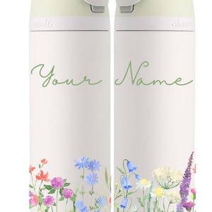 May include: Two white insulated water bottles with a light green lid and a light blue top. The bottles have a floral design with a watercolor effect. The text "Your Name" is written in green on the bottles.