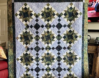Twin sized hand made quilt, pattern called Aperture. In beautiful shades of batik green and purples.