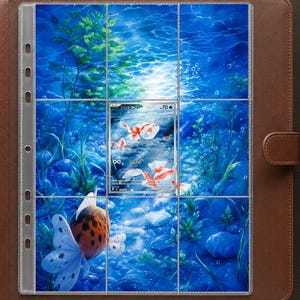 May include: A brown leather binder containing a clear plastic trading card page. The page features a vibrant underwater scene with blue water, green aquatic plants, and a single Japanese trading card depicting goldfish swimming in the center.