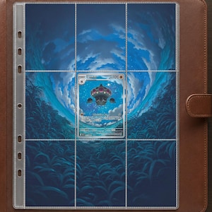 May include: A brown leather-bound trading card binder featuring a clear plastic nine-pocket page insert. A single Claydol trading card is placed in the center pocket, set against a background illustration of a dark blue, swirling sky and grass.