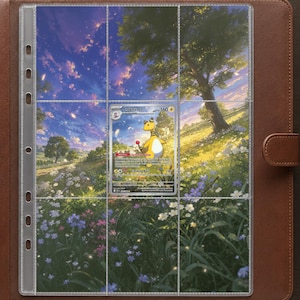 May include: A brown leather-bound trading card binder containing a clear plastic nine-pocket page. A single Ampharos Pokémon card is inserted into the center pocket, featuring a yellow character standing in a vibrant meadow with a large tree.