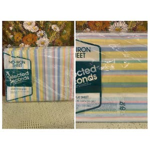 May include: A packaged set of Selected Seconds double fitted and flat sheets. The sheets have vertical stripes in pastel shades of yellow, blue, pink, and white. The packaging includes the text "NO-IRON SHEET".