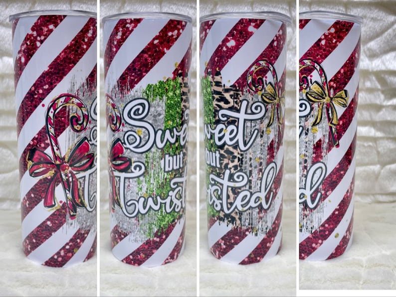 May include: A skinny tumbler with a festive design. The tumbler features a red and white striped pattern with a candy cane and bow graphic. Text on the tumbler reads "So Sweet but Twisted."
