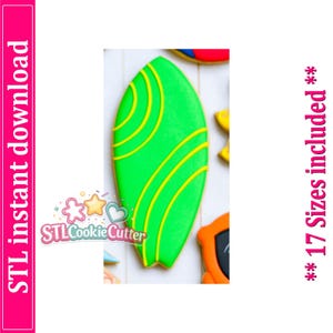 May include: A surfboard-shaped cookie decorated with bright green icing and yellow curved line accents. The image includes the text STL instant download and 17 Sizes included. The cookie has a pointed top and a notched bottom edge.