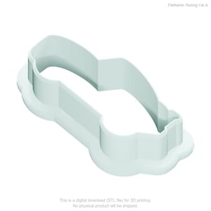 May include: A pale mint green cookie cutter shaped like a racing car. The object features a raised, thin-walled outline that forms the silhouette of a vehicle, set upon a flat, wider base plate that follows the same contour of the car shape.