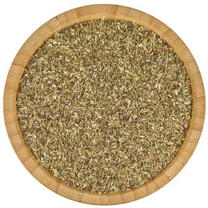 May include: A close-up view of a wooden bowl filled with dried herbs. The herbs are a light green and brown colour and are finely chopped.