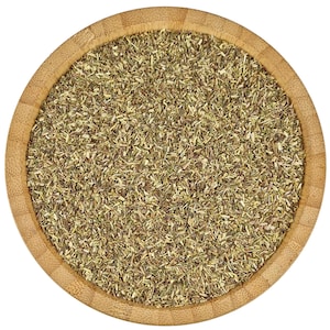 May include: A close-up view of a wooden bowl filled with dried herbs. The herbs are a light green and brown colour and are finely chopped.