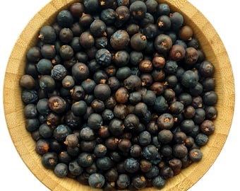 May include: A wooden bowl filled with dark blue juniper berries.