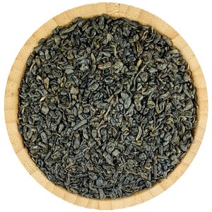 May include: A close-up of a wooden bowl filled with loose leaf green tea. The tea leaves are dark green and have a slightly curled shape.