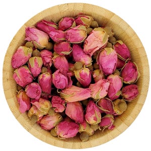Può includere: Una ciotola di legno piena di boccioli di rosa rosa secchi. I boccioli sono di colore rosa chiaro e sono disposti in modo casuale. La ciotola è fatta di legno marrone chiaro e ha una finitura liscia.