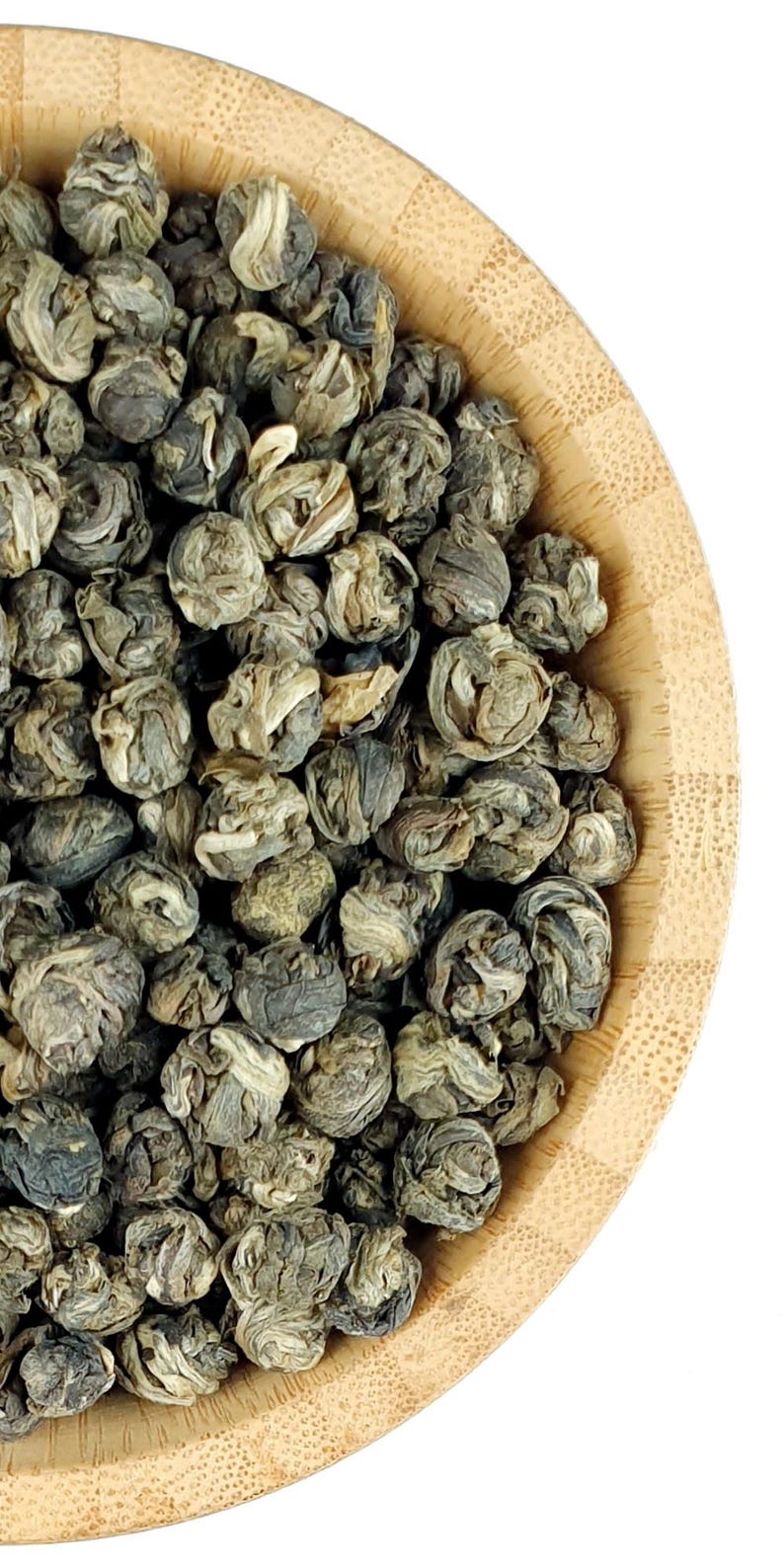 May include: A bamboo bowl filled with tightly rolled, dried green tea pearls. The tea leaves exhibit a mix of muted olive green, sage, and pale silver-white tones, showcasing a layered, spherical structure characteristic of hand-rolled tea.