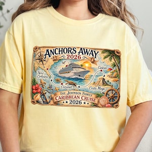 May include: A pale yellow t-shirt featuring a graphic of a cruise ship, a compass, and a map with the text Anchors Away 2026, New Orleans, Cozumel, Costa Maya, Cancun, and The Johnson Family Caribbean Cruise 2026, framed by a rope border.