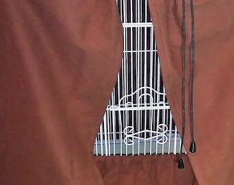 May include: A brown bird cage cover with a drawstring closure. The cover is draped over a white wire bird cage, with a portion of the cage visible. The cover is made of a soft, opaque material.