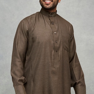 May include: A brown long-sleeved collared shirt with a button-up front and a pocket on the left side.