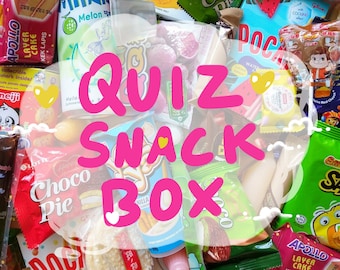 Könnte beinhalten: Eine bunte Auswahl an japanischen Snacks in einer Box. Die Snacks umfassen Schokolade, Süßigkeiten, Cracker und Kekse. Die Box ist mit "Quiz Snack Box" beschriftet.