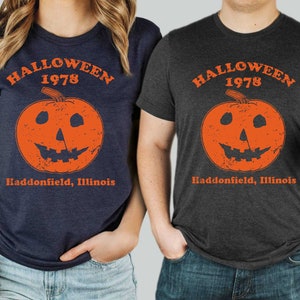 May include: Two t-shirts with a distressed orange pumpkin graphic and the text "Halloween 1978 Haddonfield, Illinois".