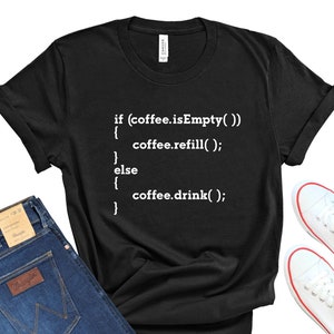 May include: Black t-shirt with white text that reads: "if (coffee.isEmpty()) { coffee.refill(); } else { coffee.drink(); }"