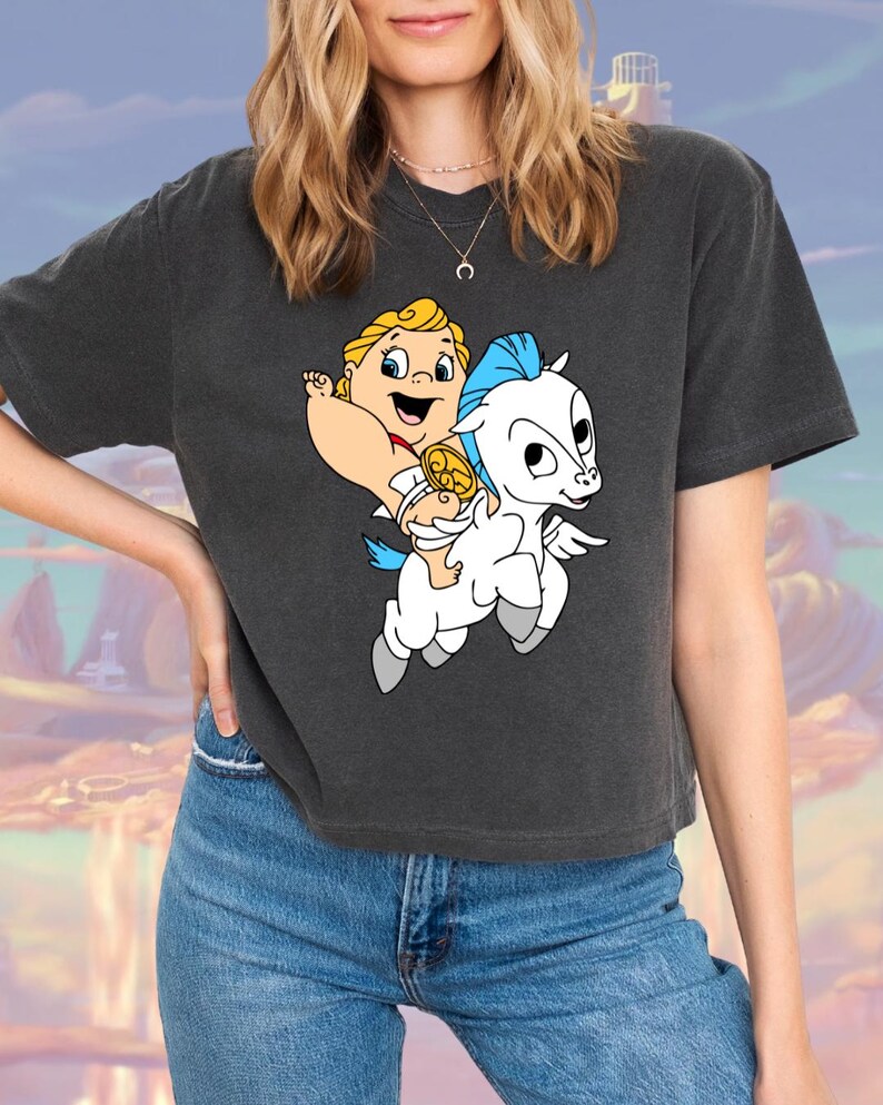 May include: A dark gray cropped t-shirt with a cartoon image of a baby Hercules riding Pegasus, a winged white horse.