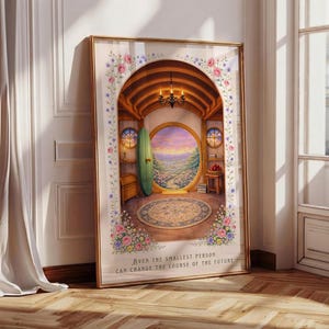 May include: Framed art print featuring a whimsical hobbit-hole interior with a round doorway overlooking a scenic landscape. The print is adorned with floral accents and the text "Even the smallest person can change the course of the future."