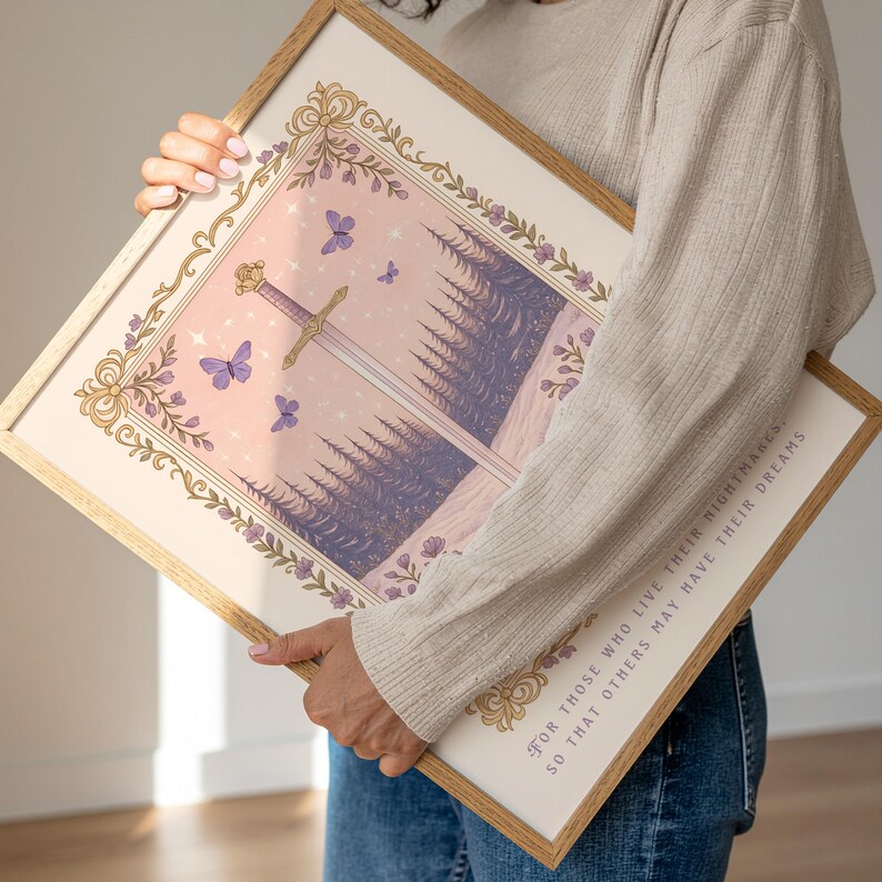 May include: A framed art print featuring a sword, butterflies, and a forest scene in shades of purple, pink, and gold. The artwork is surrounded by an ornate border and includes the text: "For those who live their nightmares so that others may have their dreams."
