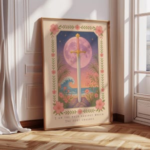 May include: Framed art print featuring a sword with a gold hilt, set against a backdrop of a full moon, ocean waves, and tropical flowers. The artwork is framed in a gold border and includes the text "I AM THE ROCK AGAINST WHICH THE SURF CRASHES."