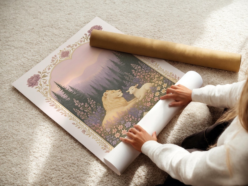 May include: A rolled art print featuring a lion and lamb in a field of flowers, with a forest backdrop. The print is framed with floral and arch details. A brown cardboard tube and a white rolled print are next to the artwork.