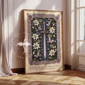 May include: A framed vertical art print featuring a central sword surrounded by white lilies and purple butterflies against a dark blue background. The border is ornate and light purple. The text reads: My armor may dent, my sword may break, but I will never diminish.