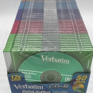 May include: A sealed 50-pack of Verbatim CD-R discs in a variety of colors. The packaging features the Verbatim logo, "DataLifePlus," and "12x Speed." Each disc holds 80 minutes or 700MB of data.