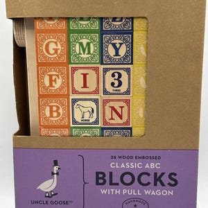 May include: A set of 28 wood embossed classic ABC blocks with a pull wagon in a brown cardboard box. The box features a window displaying colorful blocks with letters, numbers, and a horse illustration. Text reads Uncle Goose 28 Wood Embossed Classic ABC Blocks With Pull Wagon.