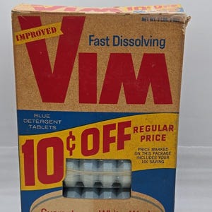 May include: Vintage box of "Vim" blue detergent tablets. The box is tan with red and yellow text, including "Improved" and "Fast Dissolving." It advertises a 10-cent discount and guarantees a whiter wash. The net weight is 2 lbs.